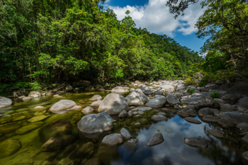 Mossman river flowing amongst the boulders at Mossman Gorge - Australian Stock Image