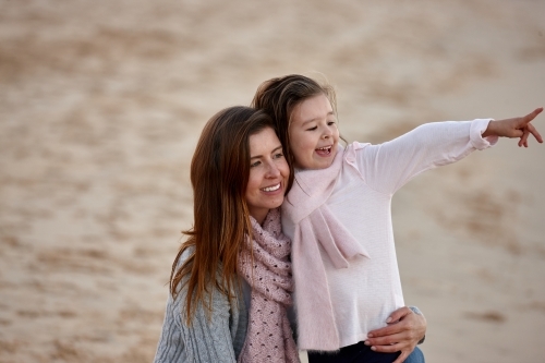 Mother and daughter at beach on sunset - Australian Stock Image