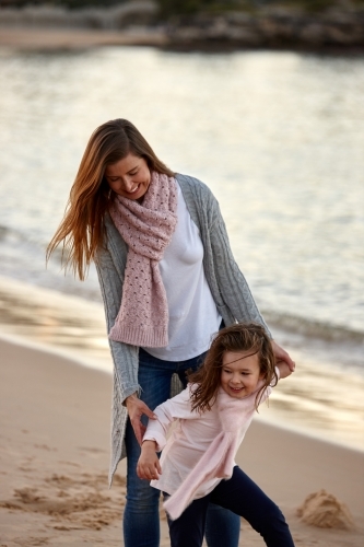 Mother and daughter at beach on sunset - Australian Stock Image