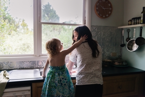 Mother and daughter at the kitchen sink