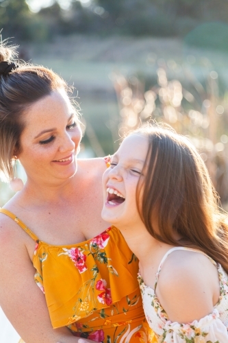 Mother and daughter laughing together - Australian Stock Image