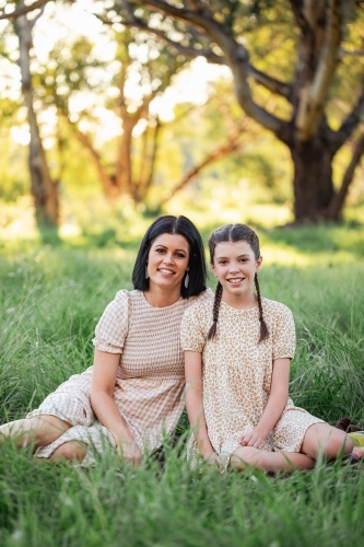 Mother and daughter sitting together in natural Australian bush setting