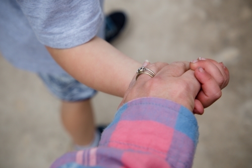 Mother and son holding hands - Australian Stock Image