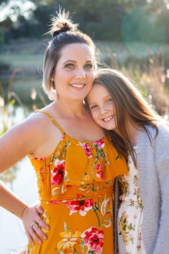 Mother and young daughter hug - Australian Stock Image
