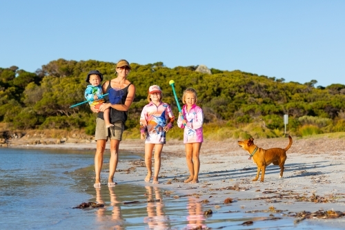 Mother with three children and pet dog at the beach - Australian Stock Image