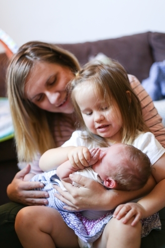 Mother with two children on her lap - Australian Stock Image