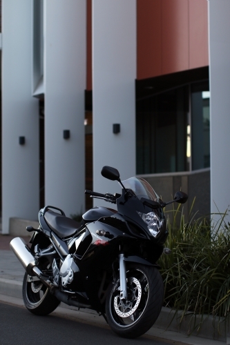 Motorbike parked on a suburban street - Australian Stock Image