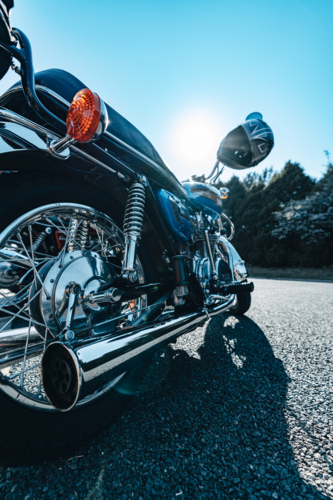 Motorbike with sunflare and helmet - Australian Stock Image