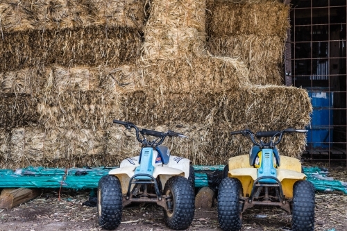 Motorbikes in hay shed - Australian Stock Image