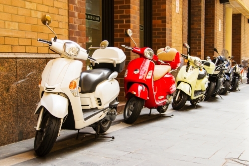 Motorbikes parked in a row in a city street - Australian Stock Image