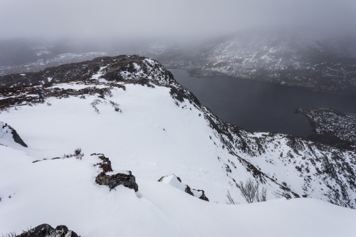 Mountains covered in snow surrounding lake - Australian Stock Image