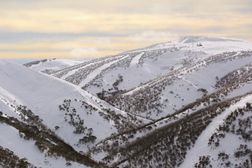 Mountains of snow at sunset - Australian Stock Image