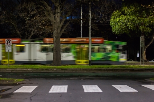 Moving tram and pedestrian crossing in a city