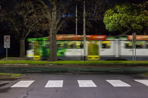 Moving tram and pedestrian crossing in a city - Australian Stock Image