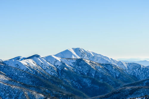 Mt Feathertop from Mt Hotham with blue sky and snow - Australian Stock Image