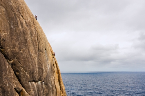 Multi pitch rock climbing over the ocean