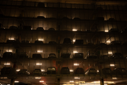 Multi story car park at the Sydney Domestic Airport illuminated at night - Australian Stock Image
