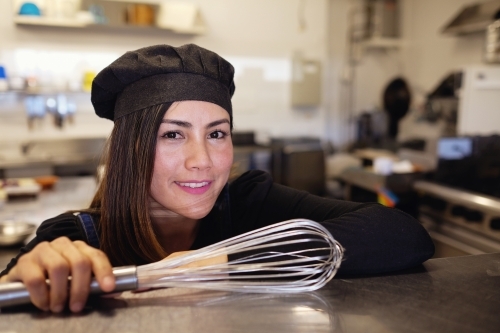 Multicultural Asian chef in small business restaurant - Australian Stock Image