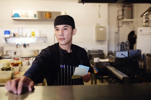 Multicultural Asian chef in Thai small business restaurant