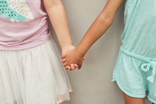 Multicultural children holding hands