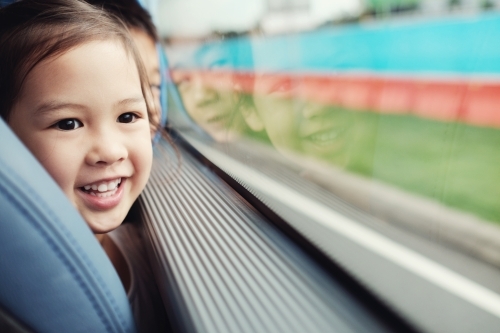 Multicultural children looking through bus window - Australian Stock Image