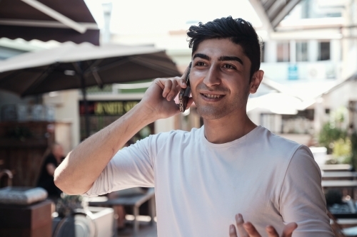 multicultural young adult man on the phone - Australian Stock Image