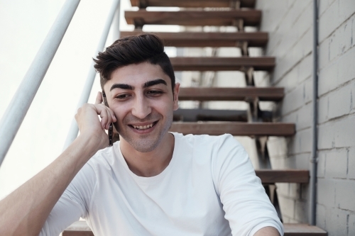 multicultural young adult man on the phone - Australian Stock Image