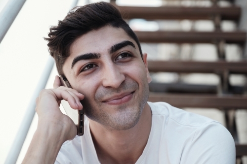 multicultural young adult man on the phone - Australian Stock Image