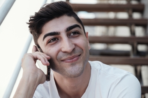 multicultural young adult man on the phone