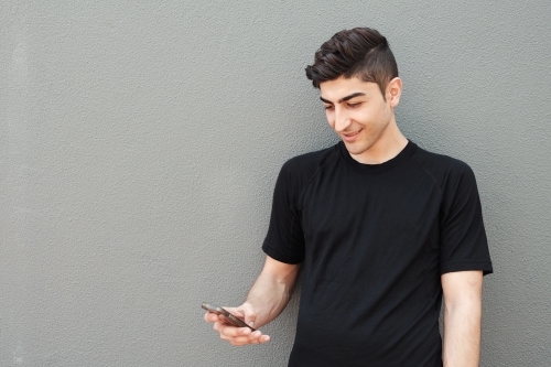 multicultural young adult man on the phone - Australian Stock Image