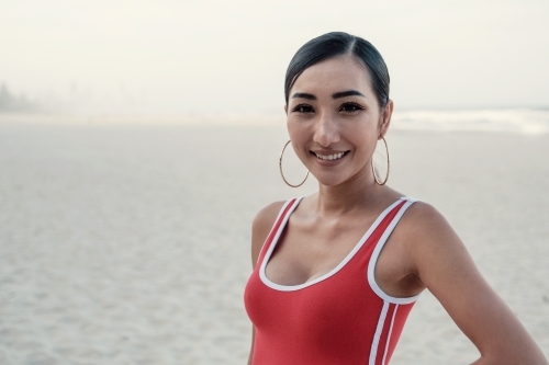 Multicultural young adult woman on the beach - Australian Stock Image