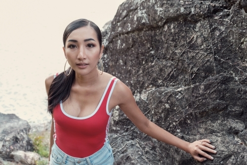 Multicultural young adult woman on the beach - Australian Stock Image