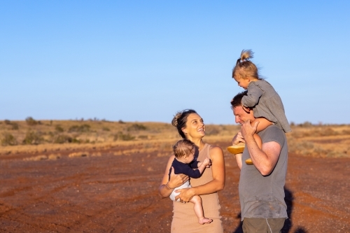 mum and dad with two little kids outdoors in the outback - Australian Stock Image