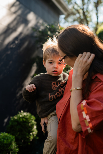 Mum holding toddler son in a sunlit garden - Australian Stock Image