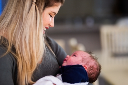 Mum smiling at baby boy - Australian Stock Image