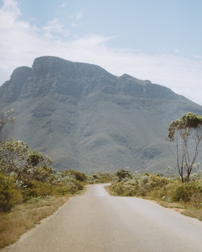 Narrow road leading to a mountain - Australian Stock Image