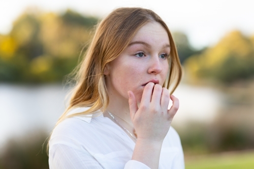 nervous teen girl with dark blonde hair - Australian Stock Image