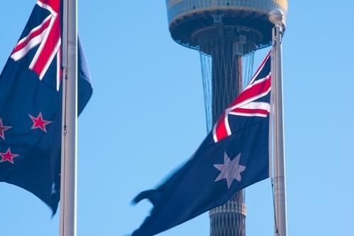 New Zealand and Australian flag in front of Sydney Tower with a blue sky - Australian Stock Image