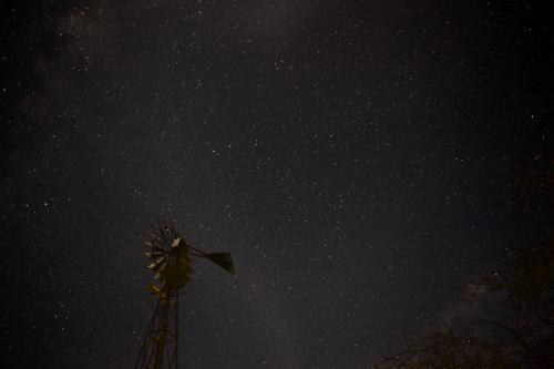 Night sky with stars and a windmill in the foreground
