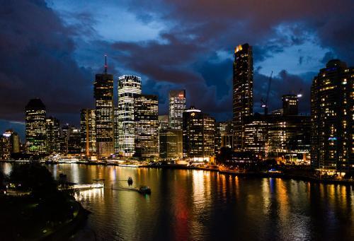Night view of City skyline and lights reflected in the Brisbane River - Australian Stock Image