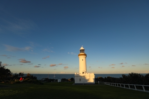 Norah Head Lighthouse on the New South Wales central coast in Australia at sunset - Australian Stock Image