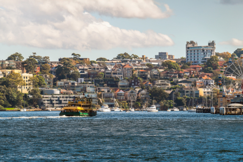 North Sydney skyline viewed from ferry departing from Circular Quay on a day - Australian Stock Image