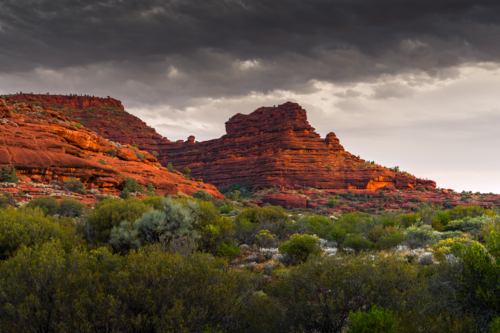Northern Territory Landscape with dark clouds above red cliffs - Australian Stock Image