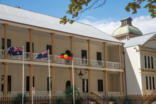 NSW Parliament building with flags and blue sky - Australian Stock Image