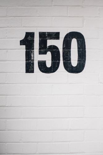 Number 150 Painted on Brick Wall