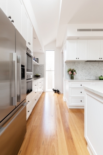Oak flooring and white cabinetry detail in a new kitchen - Australian Stock Image