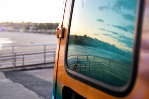 Ocean and sky reflection from van window at Bondi Beach - Australian Stock Image