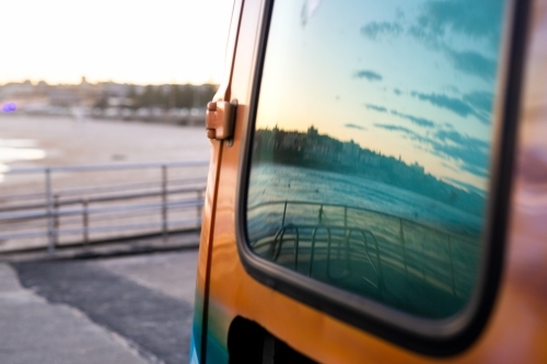 Ocean and sky reflection from van window at Bondi Beach