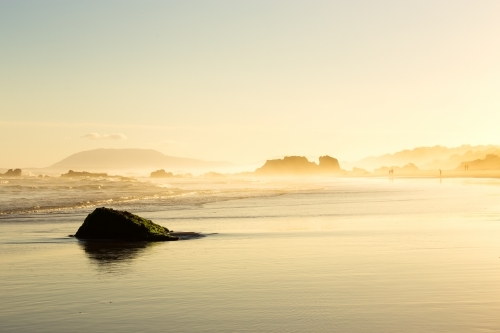 Ocean shoreline during a misty sunset - Australian Stock Image