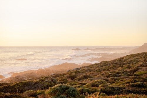 Ocean view of rugged coastline at sunset